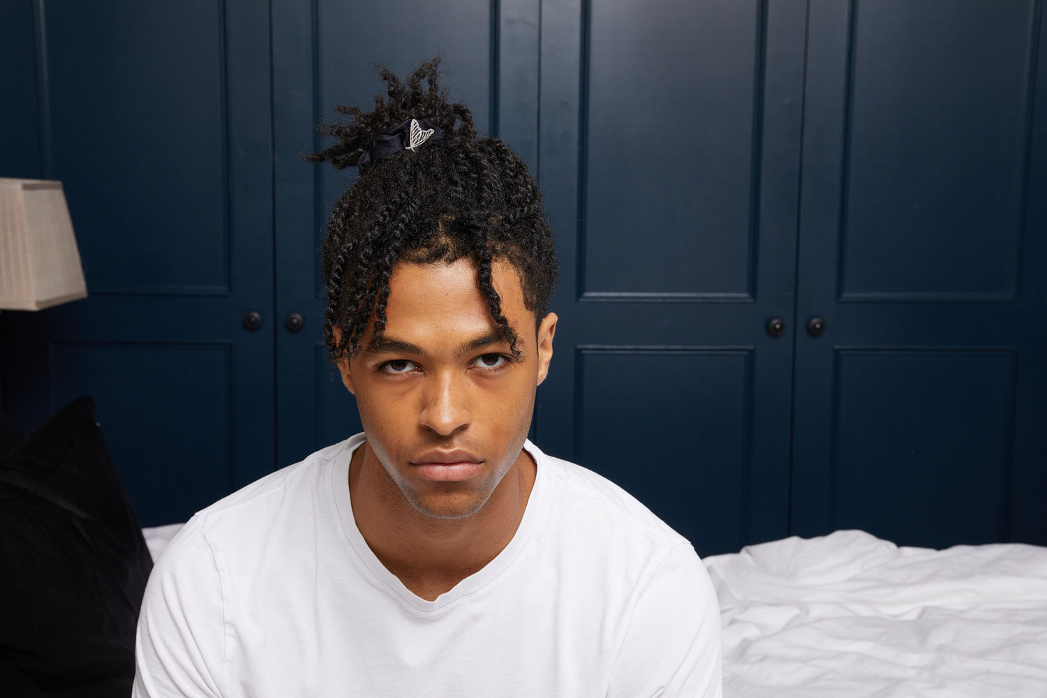 Man wearing black silk scrunchie made from cruelty free peace silk