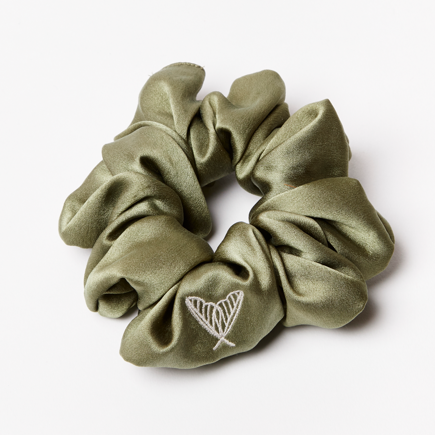Large silk scrunchie in glossy green silk with ethical peace silk logo