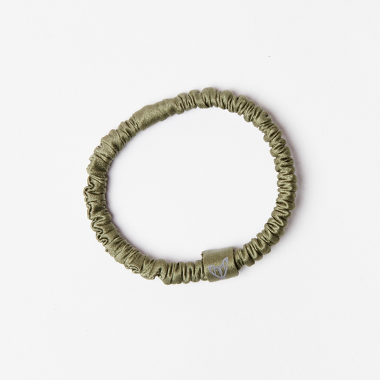 Green silk scrunchie hair tie made from glossy green silk with ethical moth logo